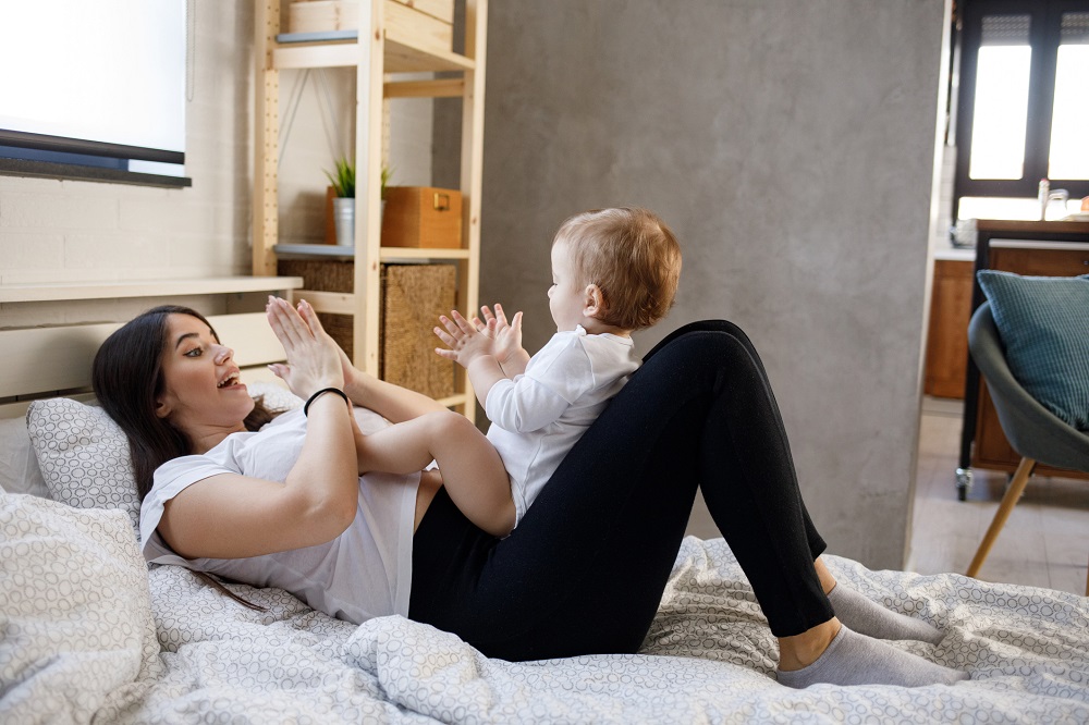 Mum singing and playing with her baby