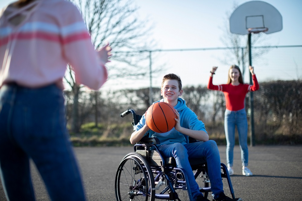 Boy in wheelchair playing basketball