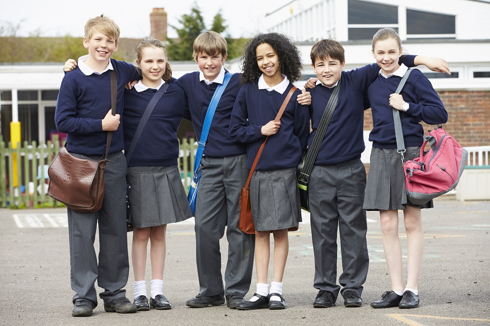 Group of school children standing in the playground