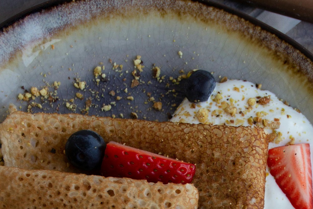Crepes with blueberries. strawberries and yoghurt