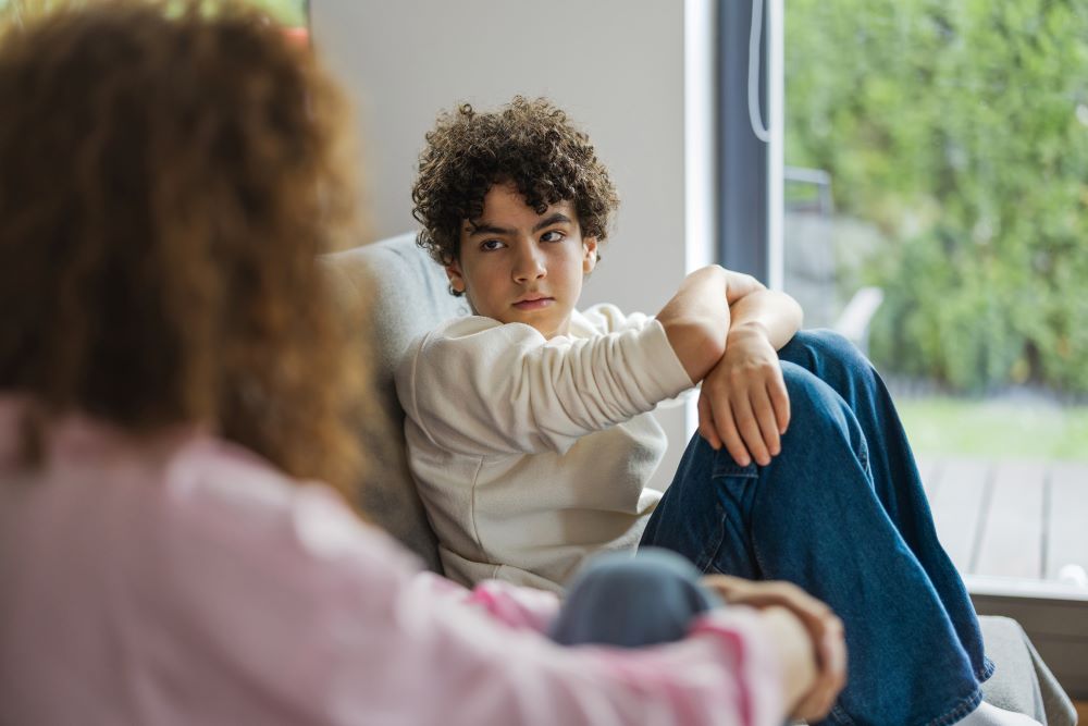 Teen boy talking to his mother.