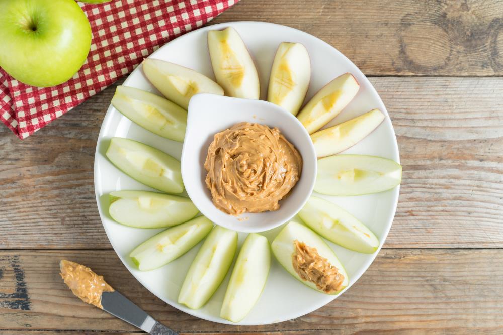 Peanut butter dip with apple slices.