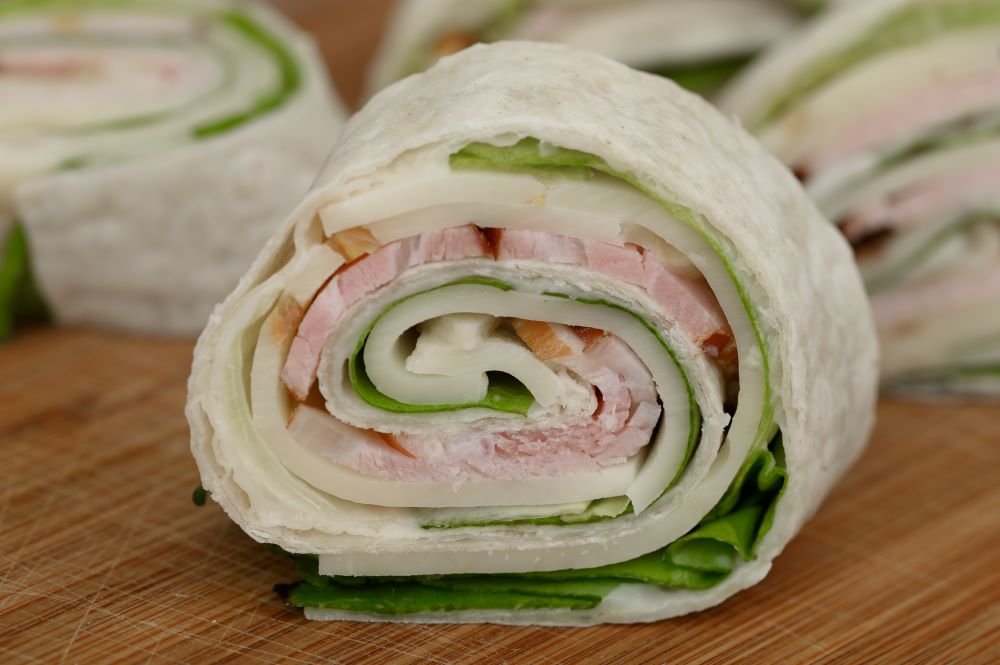 Pin wheel bites with ham and salad.