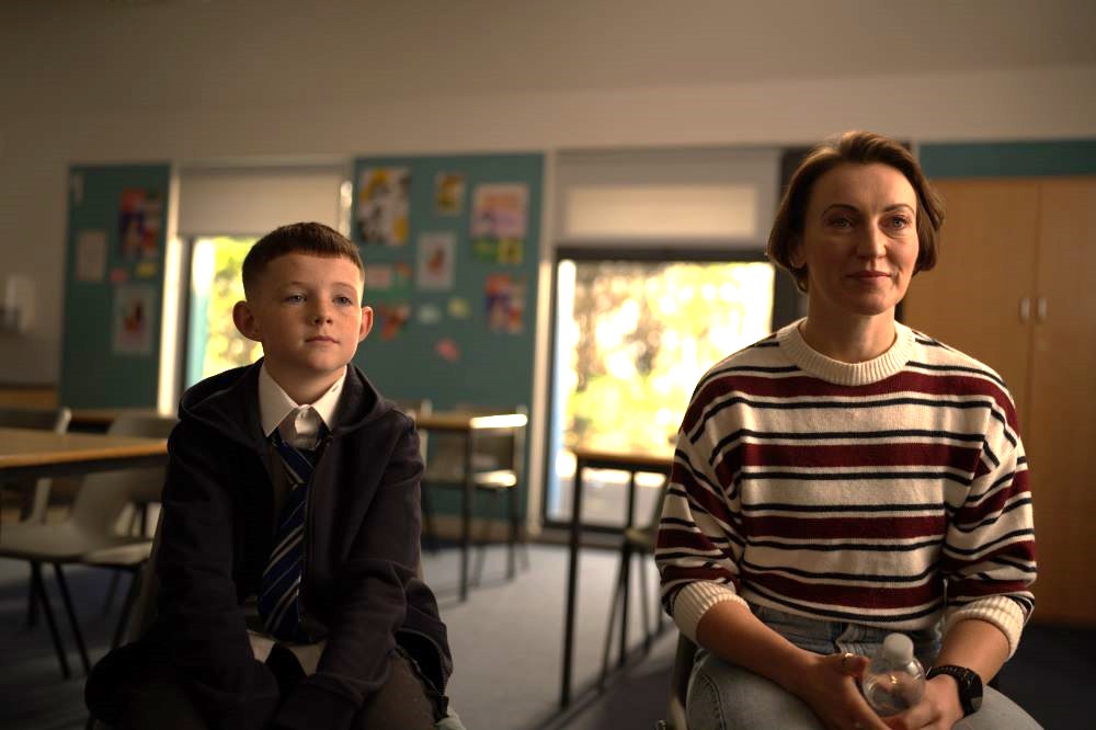 Mother and son in a school classroom