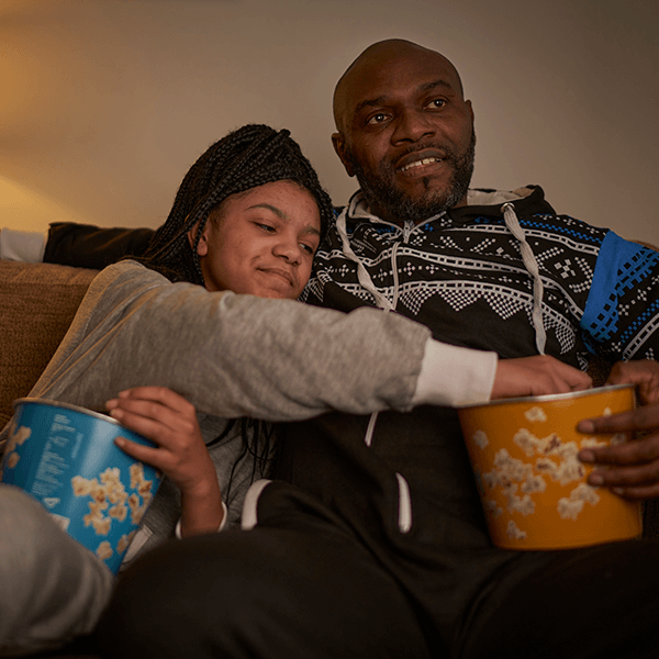 father-daughter-eating-popcorn-together-button