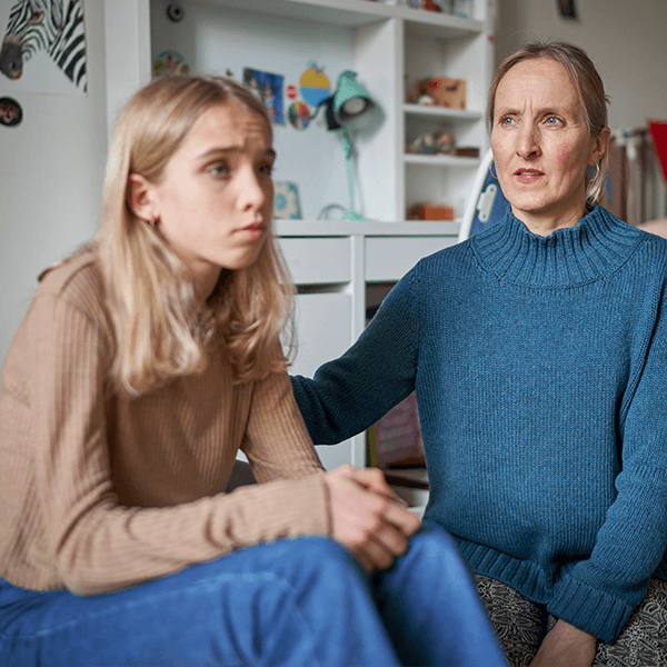 mother-looking-worried-with-teen-girl-button