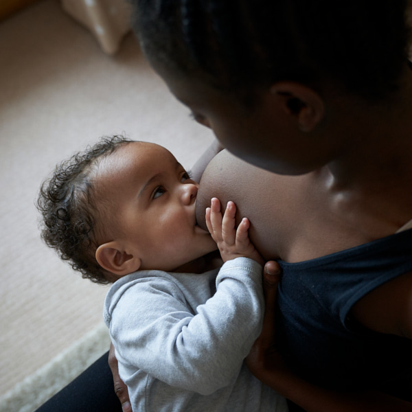 Photo of a 6 month old baby breastfeeding