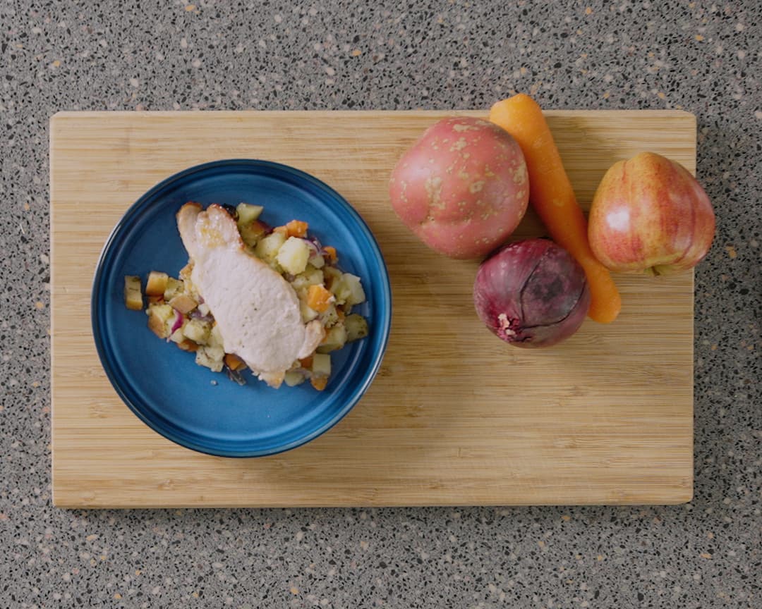 Bowl of pork tray bake with ingredients