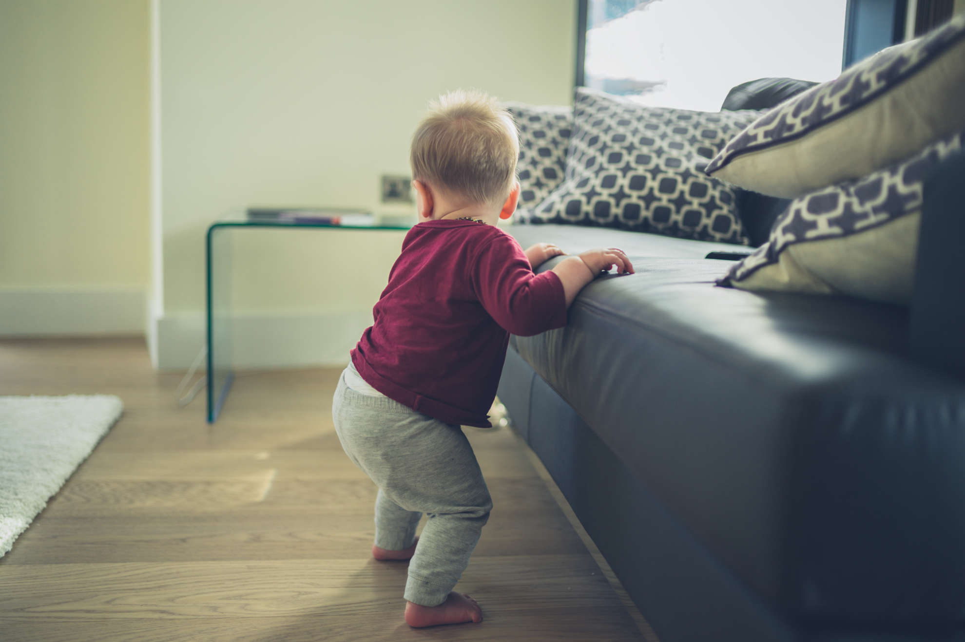 Photo of a baby learning to walk