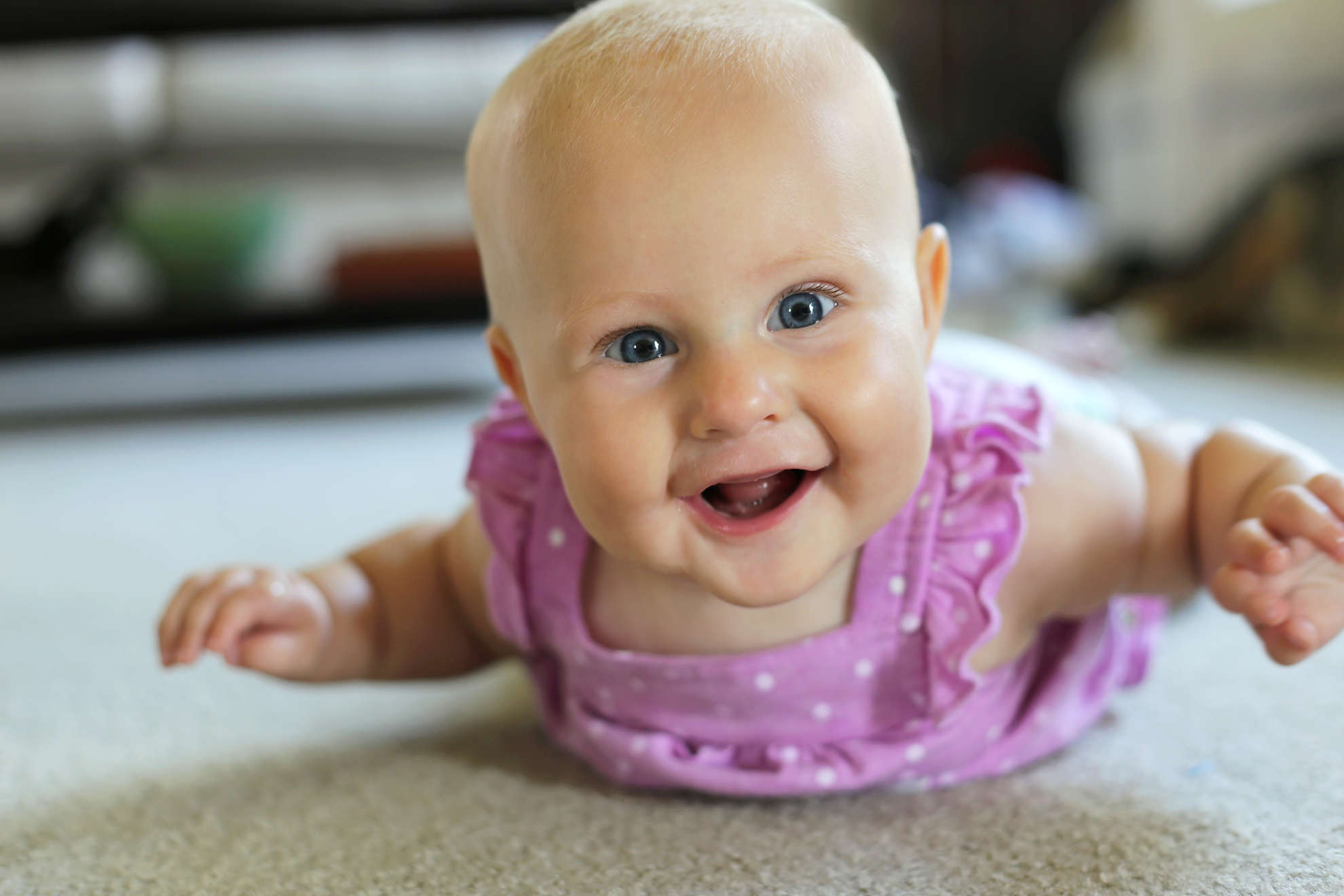 Photo of baby girl lying on tummy