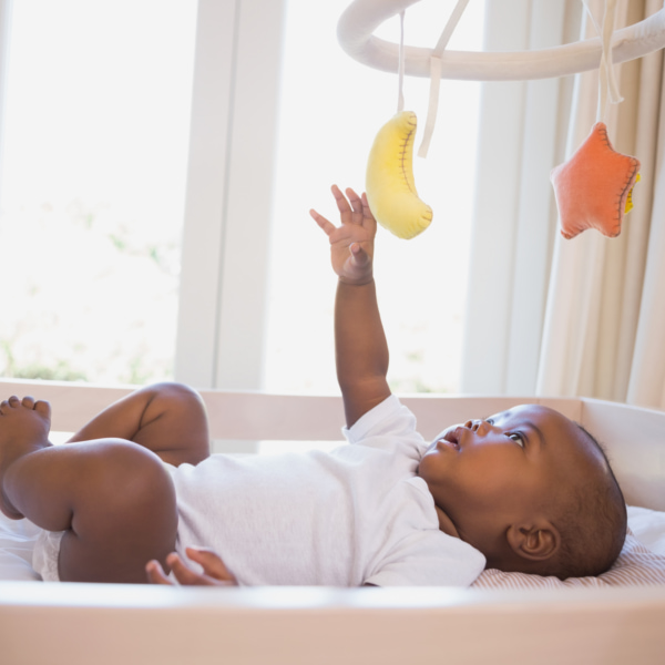 Photo of a baby reaching for their mobile 