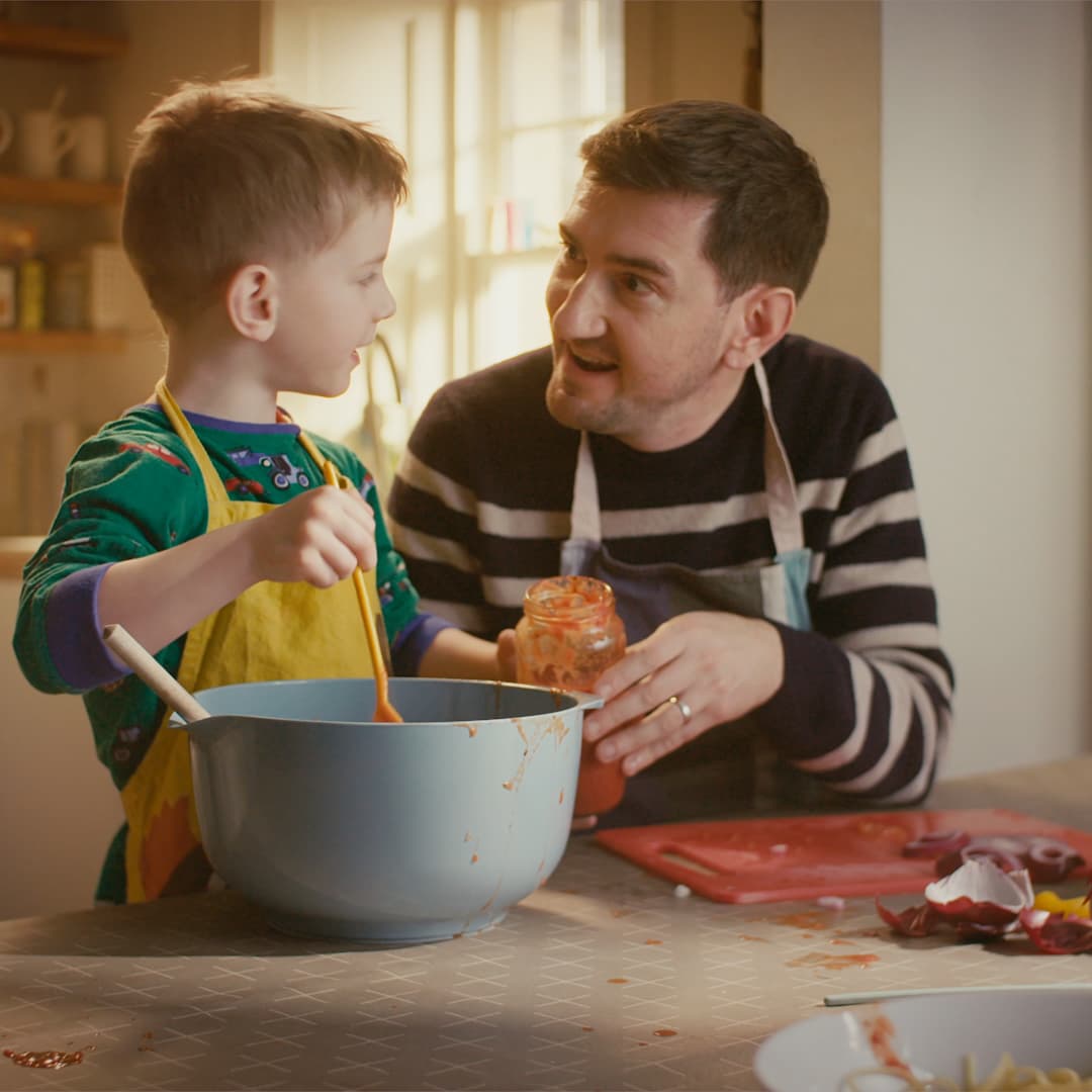 Father and son cooking together and chatting