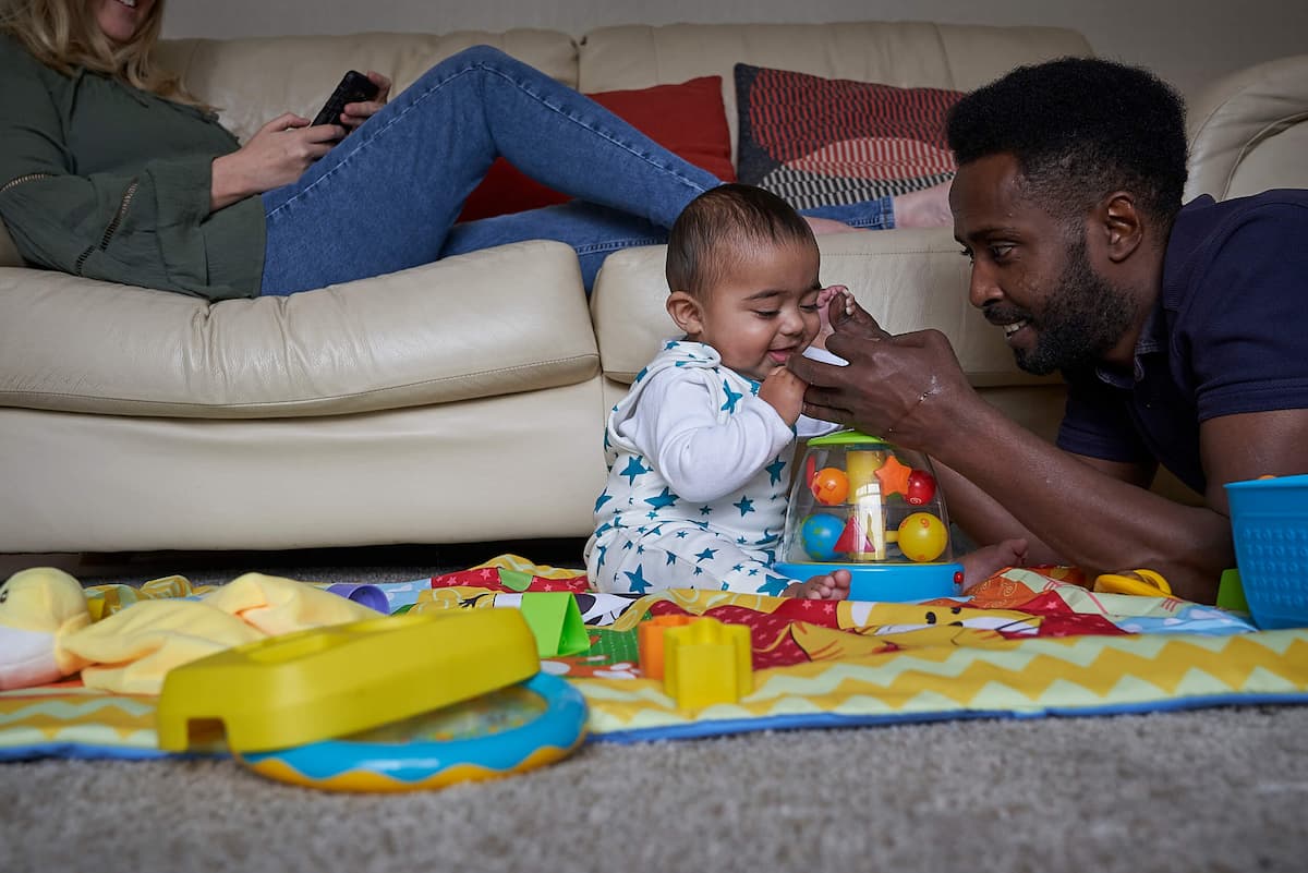 Photo of dad playing with baby