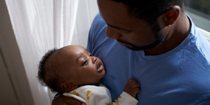 Image of a dad holding a baby.