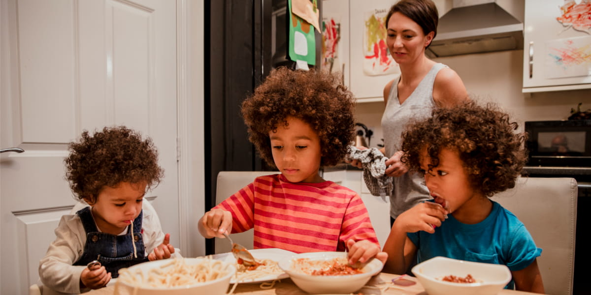 group of children eating at a table