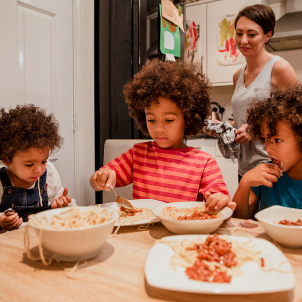 group of children eating at a table