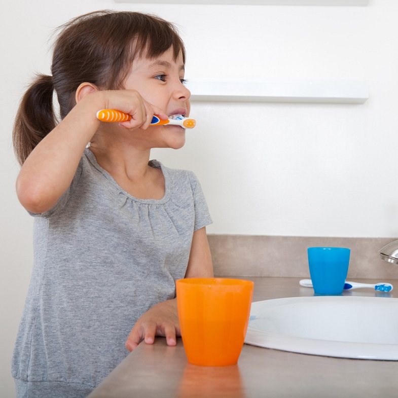 Little girl brushing her teeth