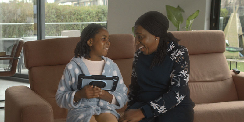 mother-daughter-laughing-together-with-tablet-banner