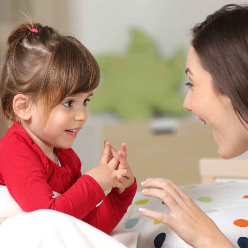 Mother and toddler talking and smiling