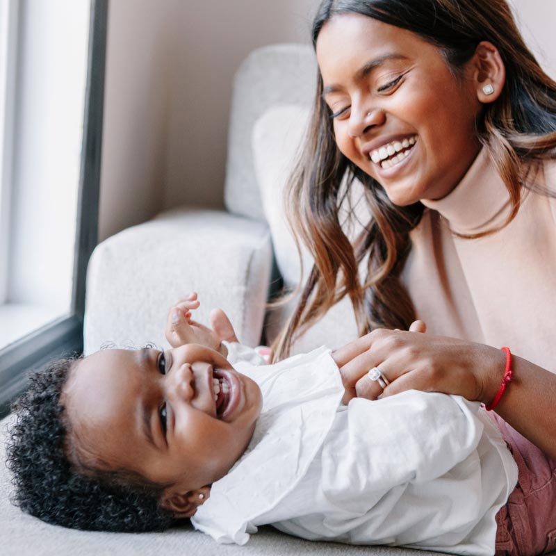 Mum and toddler playing and laughing together