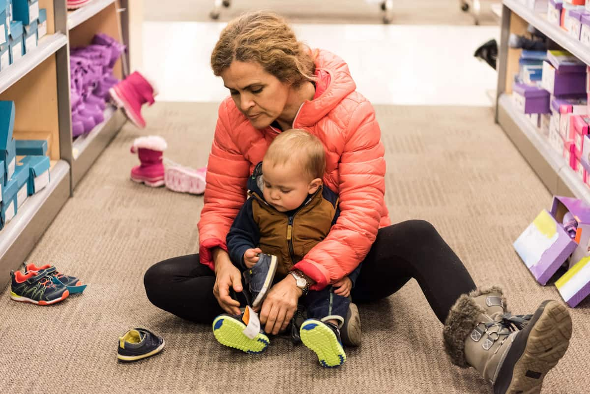 Photo of a mum putting shoes on her baby 