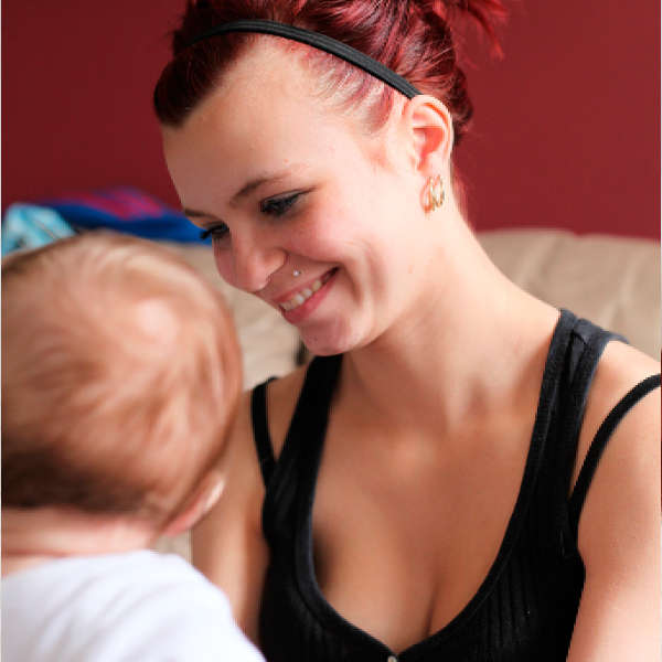 Photo of mum smiling at baby