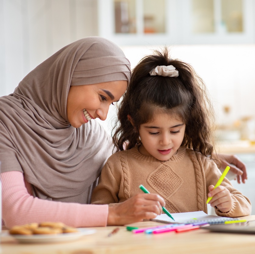 Muslim mum drawing with her daughter