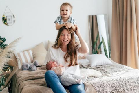 Mum with her baby and toddler playing together