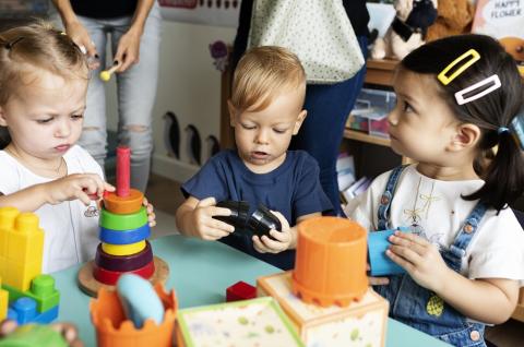 Three toddlers playing at nursery