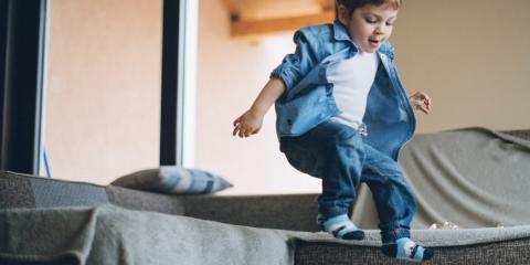 Photo of a boy jumping off the couch 