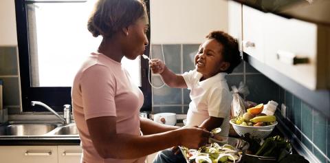 Mum and toddler preparing food in the kitchen