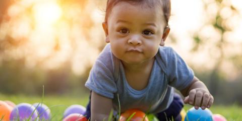 Photo of a baby crawling with balls 