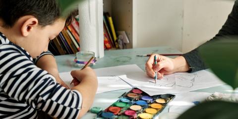 Photo of a child painting in the kitchen 