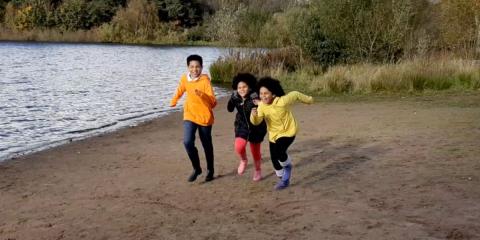 Photo of children running on the beach 