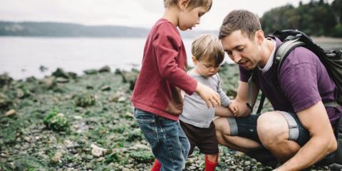 Photo of dad and children on a beach 