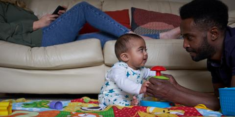 Photo of a dad playing with his baby 