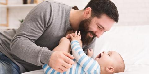 Photo of a dad tickling his baby 