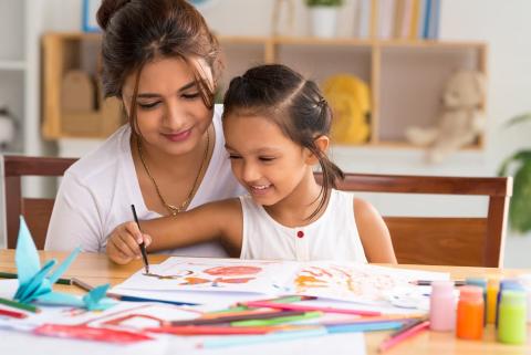 Mother and child painting together at the kitchen table