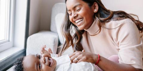 Mum and toddler playing and laughing together