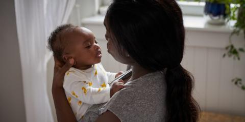 Photo of a mum holding her awake baby 