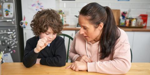 Photo of a parent and child talking to one another 