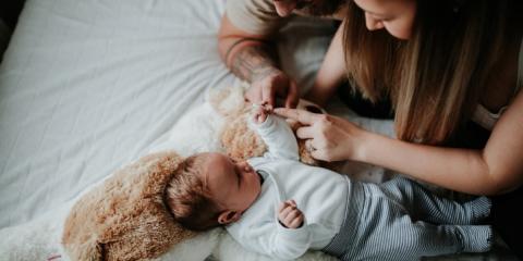 Photo of parents at home with baby 