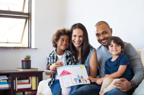 Family with two boys sitting on sofa