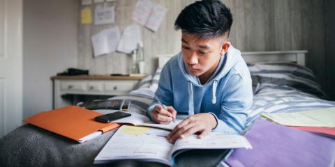 Photo of a teenager studying in their room 