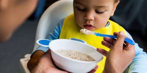 Mum feeding baby porridge