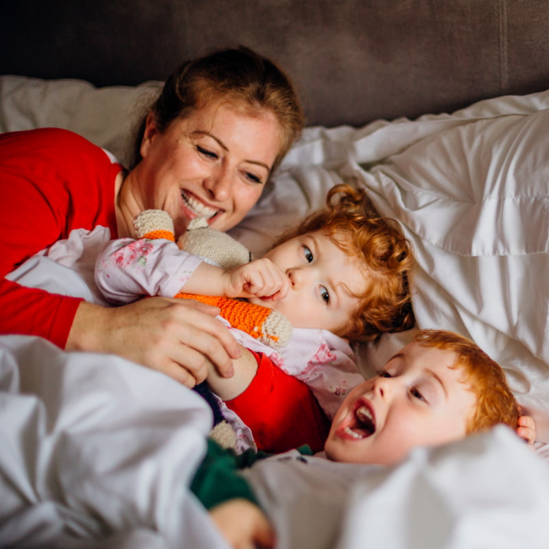 Toddler in bed with mum